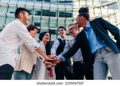 A Group Of Diverse Business People Are Outside In The Street Celebrating Their Business Success With A Team Huddle