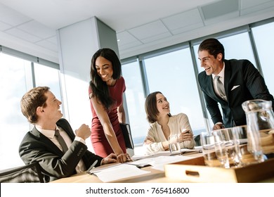 Group Of Diverse Business People Smiling During A Meeting In Office. Happy Business Colleagues Laughing In A Meeting In Conference Room.