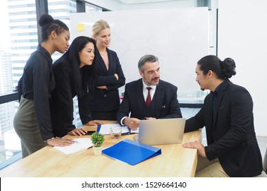 Group of diverse business people working and talking to each other in the meeting room planning new project and setting strategy. Teamwork and working lifestyle in multinational corporate concept - Shutterstock ID 1529664140
