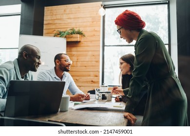 Group Of Diverse Businesspeople Having Discussions During A Boardroom Meeting. Multicultural Business Professionals Sharing Creative Ideas In An Inclusive Workplace.