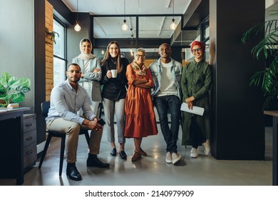 Group of diverse businesspeople smiling at the camera in a creative office. Team of multicultural entrepreneurs running a successful startup in an inclusive workplace. - Shutterstock ID 2140979909