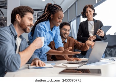 Group of diverse businesspeople using laptop while working together - Powered by Shutterstock