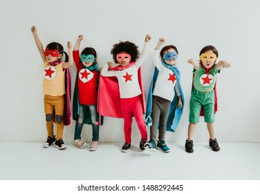 Group of Diverse Children Playing superhero on the white wall background. Superhero concept. Happy Time.
