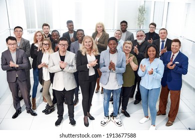 Group Of Diverse Corporate Employees Applauding Together .