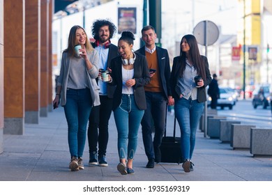 Group of diverse coworkers walking together, smiling and express - Powered by Shutterstock