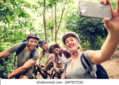 Group Of Diverse Cyclists In The Forest