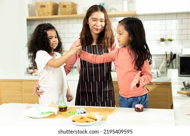 Group Of Diverse Family, Asian And Arab Preschool African Arab Kid Person Make Cake Cooking In Kitchen, Mother Prepare Decoration Pretty With Fun Educate On Snack. Cream Mess All Over Face, Copy Space