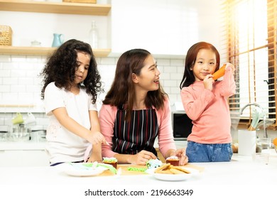 Group Of Diverse Family, Asian And Arab Preschool African Arab Kid Person Make Cake Cooking In Kitchen, Mother Prepare Decoration Pretty With Fun Educate On Snack. Cream Mess All Over Face, Copy Space