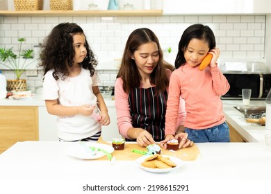 Group Of Diverse Family, Asian And Arab Preschool African Arab Kid Person Make Cake Cooking In Kitchen, Mother Prepare Decoration Pretty With Fun Educate On Snack. Cream Mess All Over Face, Copy Space