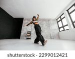 A group of diverse female dancers are in a studio posing. Shot taken from a lower wide angle perspective.