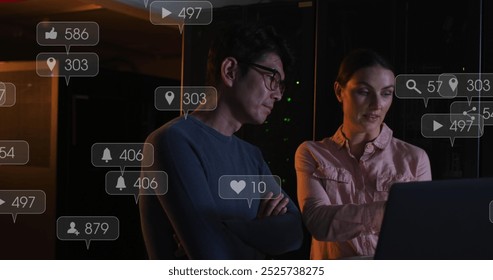 A group of diverse female and male it technicians are using laptops to check computer servers. Global social media connections and digital interface concept digitally generated image. - Powered by Shutterstock