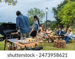 Group of diverse friend having outdoors camping party together in tent. Attractive young man and woman traveler dancing with music, enjoy hangout during holiday vacation trip in nature wood forest.