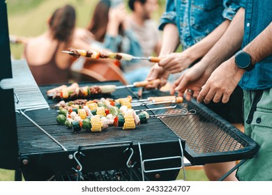 Group of diverse friend having outdoors bbq party together, camping activity lifestyle in summer, cooking fun and happy together with friends or family person group having relax in vacation time - Powered by Shutterstock