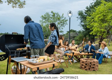 Group of diverse friend having outdoors camping party together in tent. Attractive young man and woman traveler dancing with music, enjoy hangout during holiday vacation trip in nature wood forest. - Powered by Shutterstock