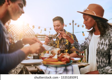 Group of diverse friends having dinner al fresco in urban settin - Powered by Shutterstock