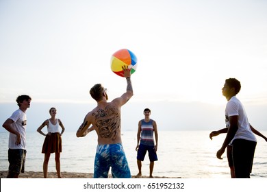 Group of diverse friends playing beach ball together - Powered by Shutterstock