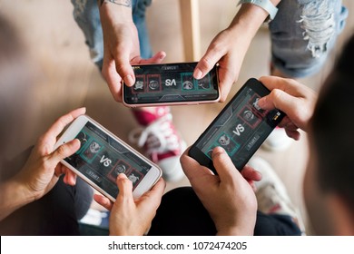 Group of diverse friends playing game on mobile phone - Shutterstock ID 1072474205