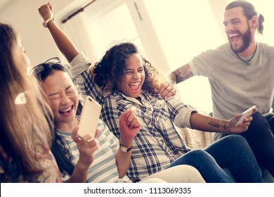 Group Of Diverse Friends Playing Game On Mobile Phone