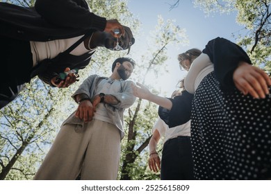 Group of diverse friends sharing a carefree, joyful moment outdoors in a sunny urban park, surrounded by nature and laughter as they blow bubbles. - Powered by Shutterstock