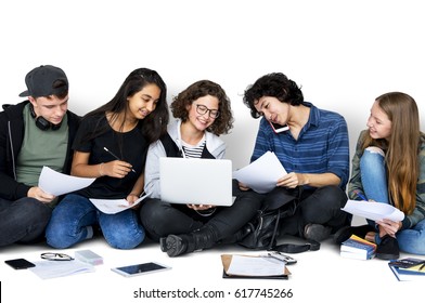 Group Of Diverse High School Students Reading Text Book Tutorial