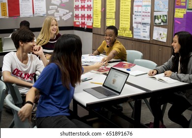 Group of diverse high school students studying in class