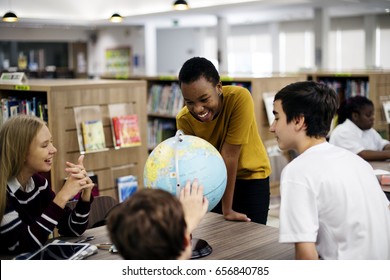 Group Of Diverse High School Students With Globe Ball