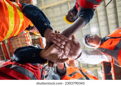 Group of diverse industrial worker work together in manufacturing plant. Attractive industry factory engineer people stack hands to motivate and working as unity teamwork at manufactory warehouse. - Powered by Shutterstock