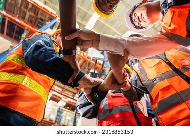 Group of diverse industrial worker work together in manufacturing plant. Attractive industry factory engineer people stack hands to motivate and working as unity teamwork at manufactory warehouse. - Shutterstock ID 2316853153