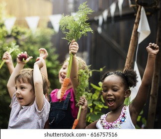 Group Of Diverse Kids Learning Environment At Vegetable Farm