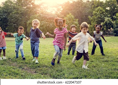 Group Of Diverse Kids Playing At The Field Together