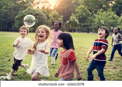 Group Of Diverse Kids Playing At The Field Together