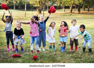 Group Of Diverse Kids Playing At The Field Together