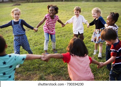 Group Of Diverse Kids Playing At The Field Together