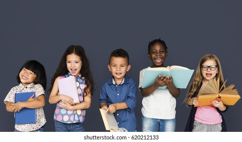 Group Of Diverse Kids Reading Books Together Studio Portrait