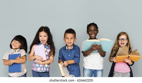 Group Of Diverse Kids Reading Books Together Studio Portrait