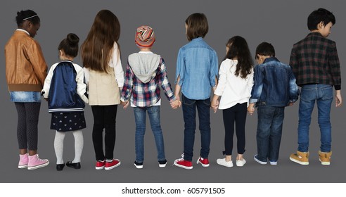 Group of diverse kids students standing in a row holdings hands - Shutterstock ID 605791505