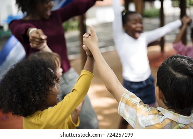 Group Of Diverse Kindergarten Students Hands Up Together