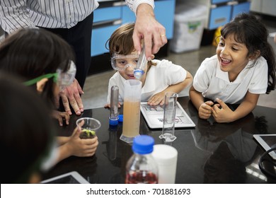 Group of diverse kindergarten students learning science class