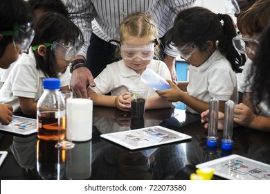 Group Of Diverse Kindergarten Students Learning Planting Experiment In Science Laboratory Class