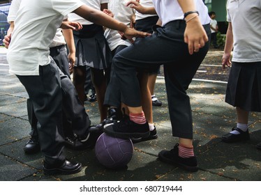 Group Of Diverse Kindergarten Students Playing Soccer Together