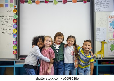 Group of diverse kindergarten students standing together
