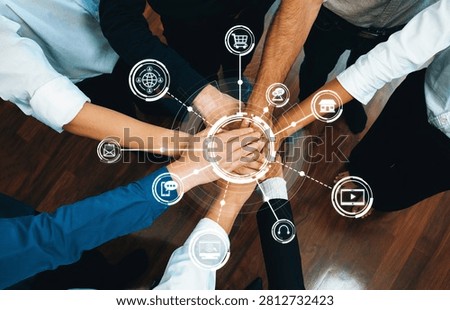 Group of diverse office worker join hand together in office room symbolize business synergy and strong productive teamwork in workplace. Cooperation and unity between business employee. Prudent Amity