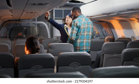 Group Of Diverse Passengers Boarding On Airplane Seats, Talking To Flight Attendant On Airline Service. Flying And Travelling With Commercial Airline, Chatting With Stewardess About Service.