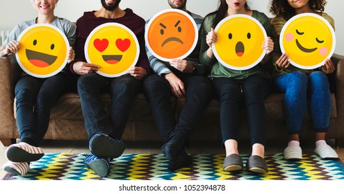 Group Of Diverse People Holding Emoticon Icons