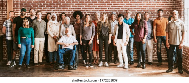 Group of diverse people standing in front of a brick wall - Shutterstock ID 1972281839