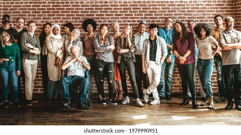 Group Of Diverse People Standing In Front Of A Brick Wall