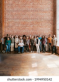 Group Of Diverse People Standing In Front Of A Brick Wall