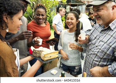 Group Of Diverse People Testing Cheese At Food Stall