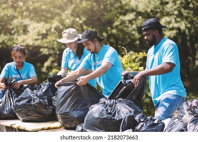 Group Of Diverse People Volunteer Teamwork ,volunteering Spirit Help To Clean Park Area In Environment Conservation.