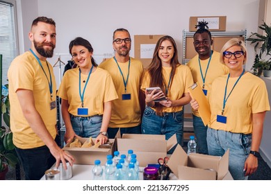 Group of diverse people working in charitable foundation. Happy volunteer separating donation stuff. Volunteers sort donations during food drive. Working as a team to help the ones in need. Copy space - Powered by Shutterstock